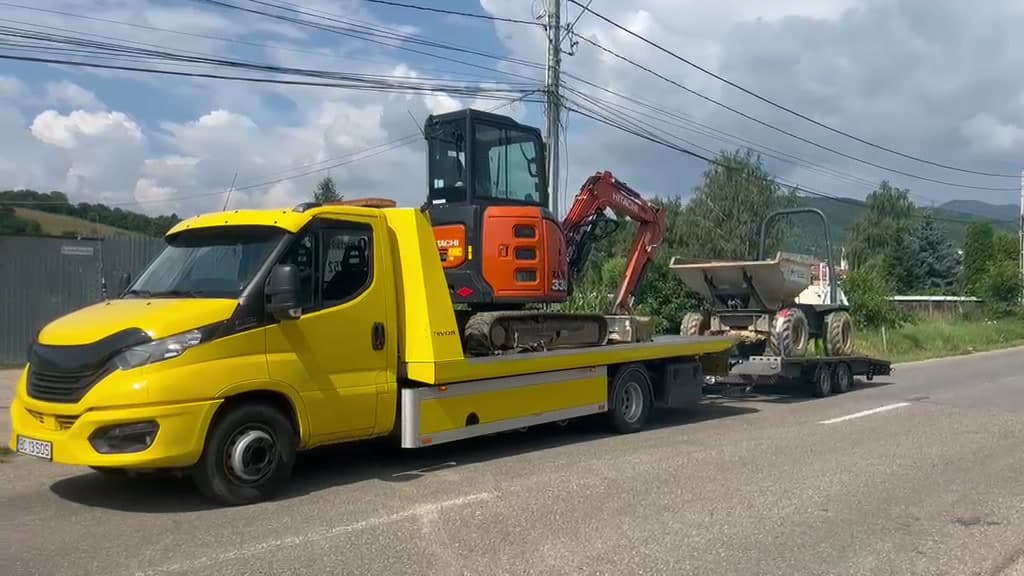 Transport utilaj de construcții pe platformă auto